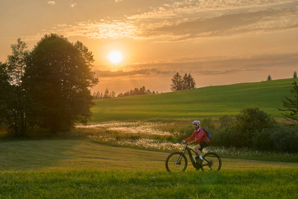 istock woman with electric bicycle  at sunset in Austria 1405420966