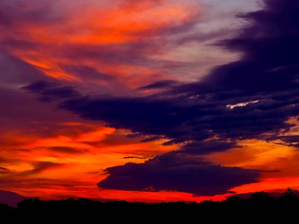 istock Dramatic red sunset in moody dark sky. 1405422900