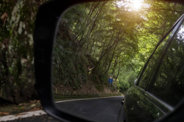 istock Mountain road in car rearview mirror 1405423444
