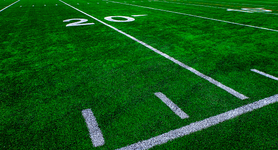 Football field green grass white yard markers to touchdown competition game