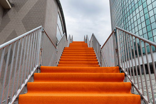 Hand using handrail for wheelchair. Man support. Steel construction. Mall escalator safety guard. Disabled ramp