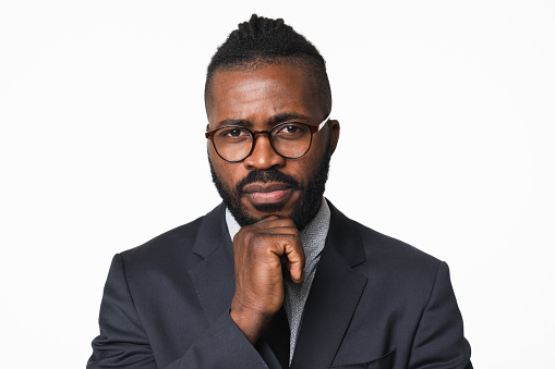 African-american young businessman ceo boss leader bank employee manager in formal suit and glasses pensive thinking about deadline isolated in white background