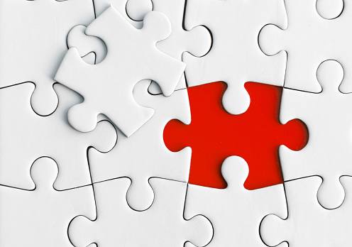 White jigsaw puzzle as mock up copy space on blue background.