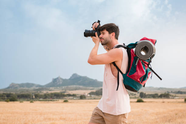 istock Man with hiking backpack and camera outdoors 1405428699