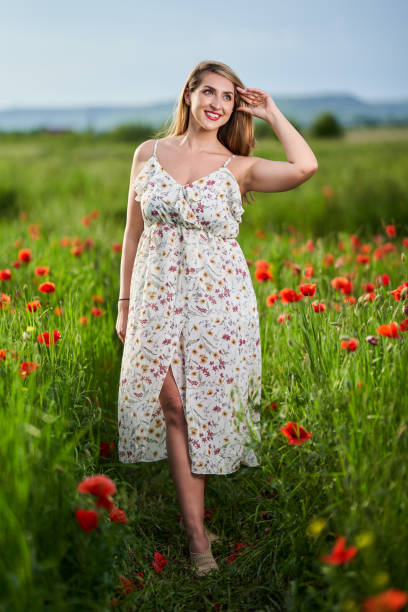 istock Beautiful plus size woman in a poppy field 1405433391