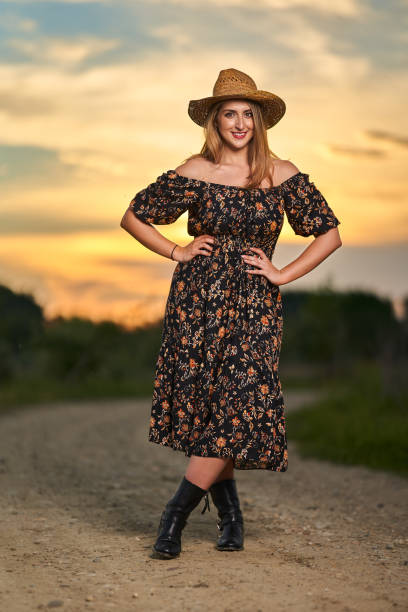 istock Pretty plus size farmer lady at sunset 1405433448
