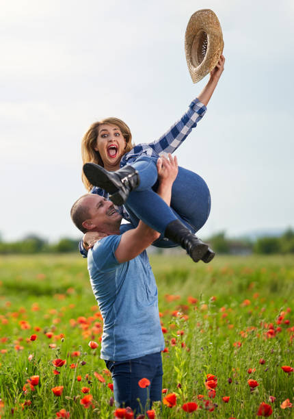 An attractive young African American Woman and a Caucasian Man get engaged on a mountain.