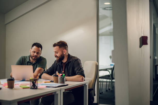 istock Two male colleagues having a meeting in an office and using a laptop 1405434683