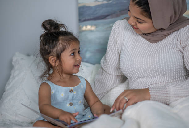 istock Muslim Mother and Daughter Reading 1405436418
