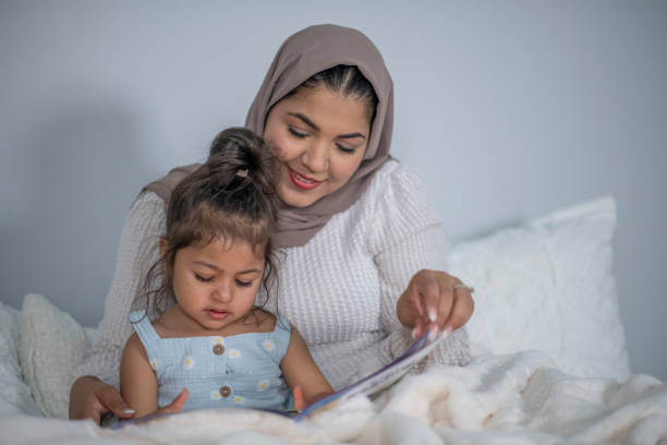 istock Muslim Mother and Daughter Reading 1405436448
