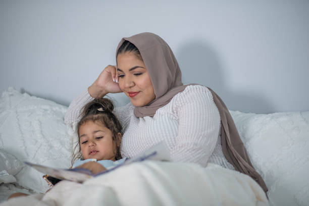 istock Muslim Mother and Daughter Reading 1405436450