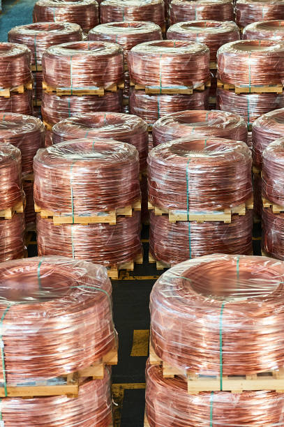 istock Rows of wrapped copper cable coils in light plant warehouse 1405436479