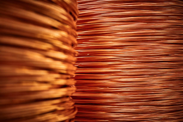 istock Large bobbin of orange copper wire in light warehouse 1405436549