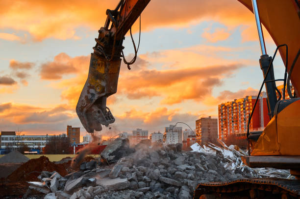 istock Crusher destroys reinforced concrete at demolition site 1405436701