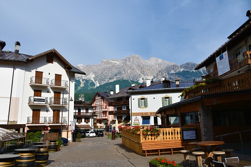 Cortina d ampezzo, Italy - June 21 2022: Street in the town of Cortina d ampezzo in Veneto region and Belluno province in Italy and mountain Cima Tofana