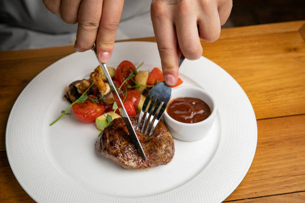 istock Steak with garnish and sauce on a plate 1405439624