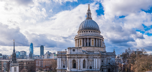 The iconic dome of St. Paul’s Cathedral overlooking the landmarks along the River Thames in the heart of London, UK.