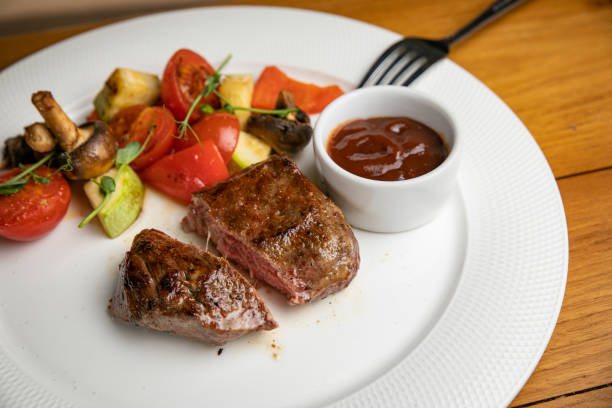 istock Steak with garnish and sauce on a plate 1405440313