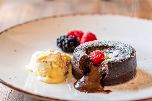 istock Chocolate fondant (cupcake) with raspberries, ice creme and powdered sugar placed on plate 1405442063