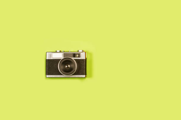 istock Vintage photographic camera on a green background 1405444686