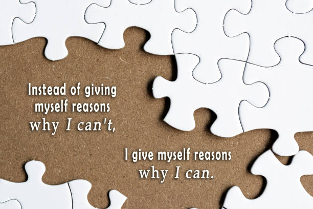 istock Motivational quote on white jigsaw with some missing pieces on brown background. 1405444890