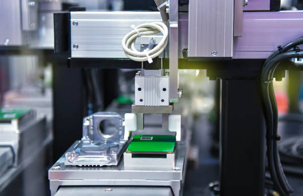 istock High technology and modern automatic robot for print circuit board (PCB)assembly machine part or component at factory 1405445244