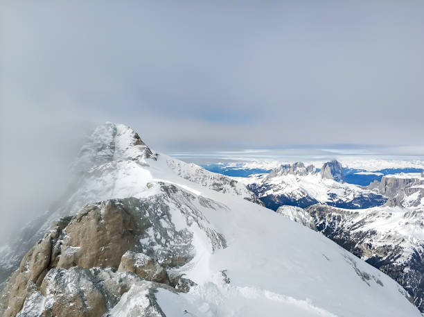 istock Snowy mountain tops in clouds 1405445661