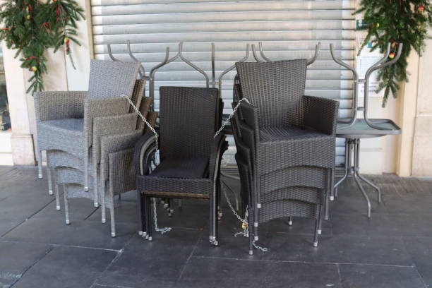 istock stacked chairs grouped and chained anti-theft- 1405447907
