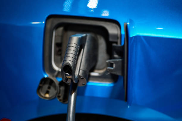 istock Charging electric automobile with plug at power station 1405447944