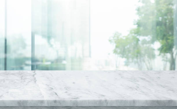 istock Selective focus.Marble table top on blur abstract cwindow glass background. 1405450053