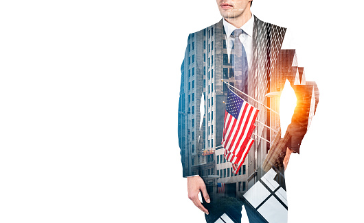 Businessman in suit with hand in pocket, double exposure with stock exchange building in New York at golden hour. Concept of finance. Copy space