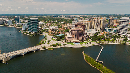 Aerial Drone View of the Waterfront Inlet in Downtown West Palm Beach, Florida & Palm Beach at Midday in June 2022