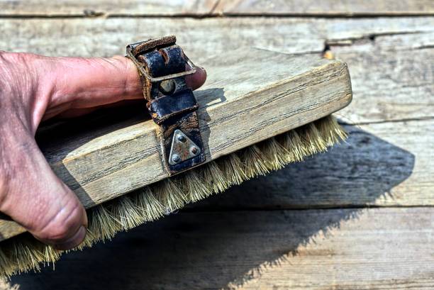 istock hand holds a brush on a black leather strap 1405452387