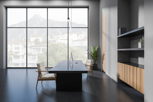 istock Grey business interior with chairs and desk, decoration and panoramic window 1405452767