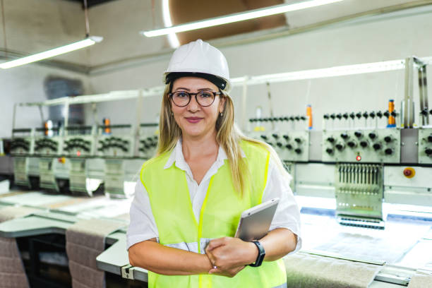 istock Female engineer working with manufacturing equipment in a factory 1405453228