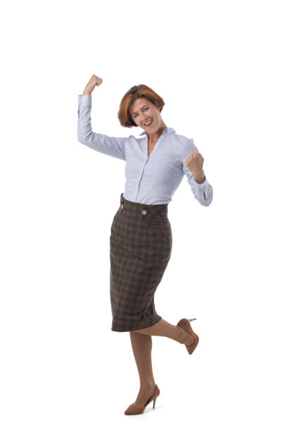 Full length portrait of happy business woman with arms raised isolated on white background