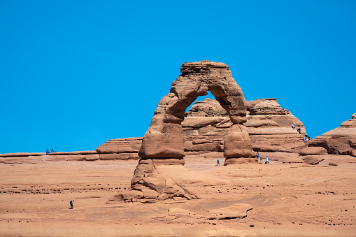 Delicate Arch in Arches National Park is the most famous arch in the world. To reach it one need to walk a long strenuous hike under the hot sun. Located in Arches National Park and seen at daytime in the summer.