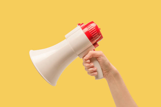 istock Megaphone in woman hands on a white background. 1405460908