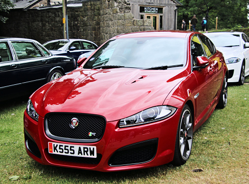 Oswestry in Shropshire in the UK in June 2022. A view of a Jaguar XF car on the grass