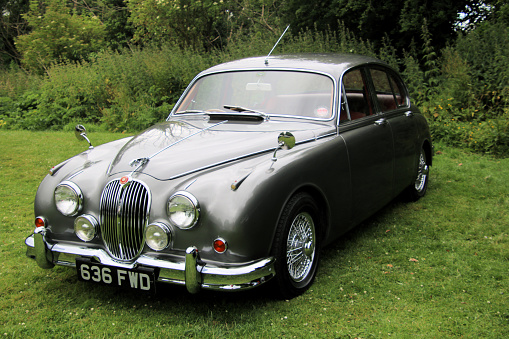 Oswestry in Shropshire in the UK in June 2022. A view of a Jaguar S Type car in a field