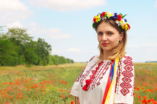Latvian woman in traditional clothing posing on nature background in village. Ligo festival. Riga. Latvia