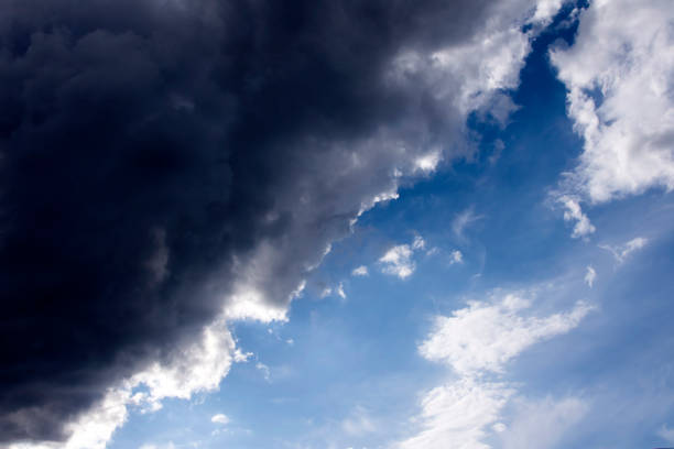 istock a dark cloud covers the blue sky. before the storm and thunder 1405469048