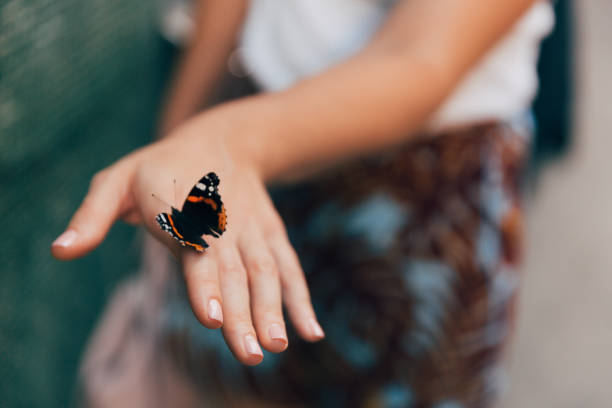 istock Women holding a butterfly 1405469706