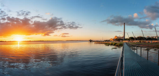Panoramic view of Sunset at Guaiba River with Gasometro Power Plant (Usina do Gasometro) and Moacyr Scliar Park and - New Guaiba Revitalized Waterfront (Orla do Guaiba) - Porto Alegre, Rio Grande do Sul, Brazil Panoramic view of Sunset at Guaiba River with Gasometro Power Plant (Usina do Gasometro) and Moacyr Scliar Park and - New Guaiba Revitalized Waterfront (Orla do Guaiba) - Porto Alegre, Rio Grande do Sul, Brazil porto grande stock pictures, royalty-free photos & images