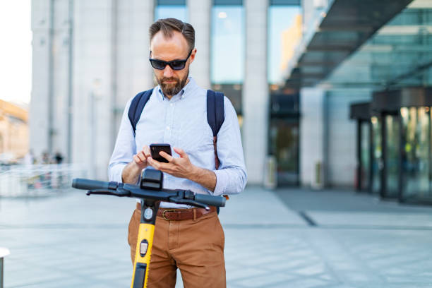 istock Young man renting electric scooter using smartphone 1405471870