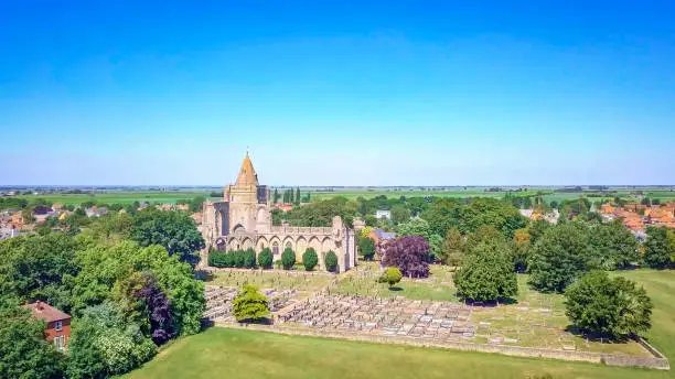 Aerial shot of Crowland Abbey, Lincolnshire, Peterborough on a glorious summer day with perfect blue sky