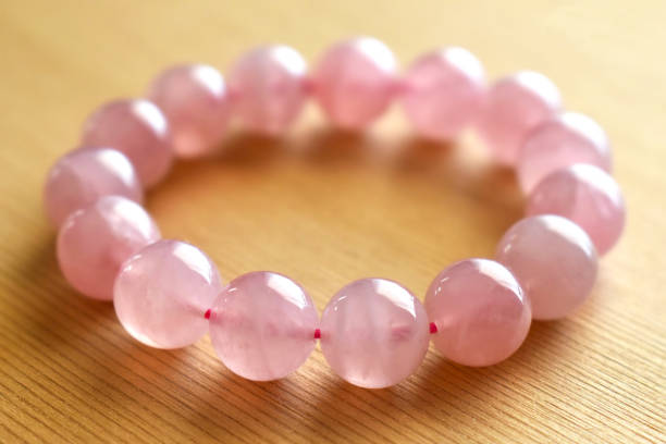 Rose quartz bracelet on the table. The love magnet, unconditional love, forgiveness and compassion crystal gemstone.