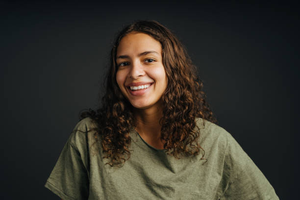 istock Smiling young woman with curly hair in studio 1405476368