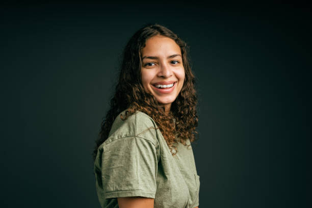 istock Smiling young woman with curly hair in studio 1405476380
