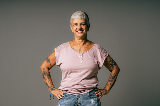 Gray haired tattooed woman in studio